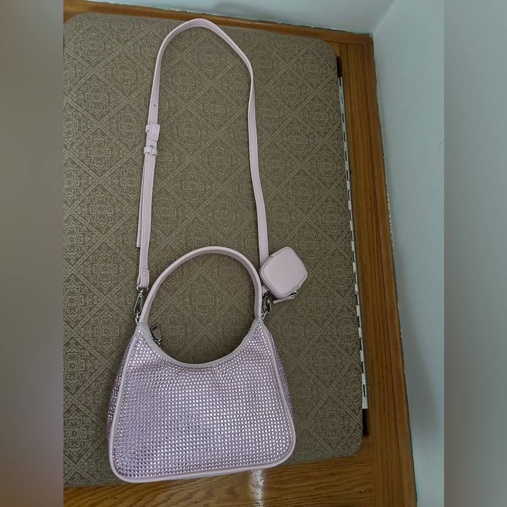 Used pink bag with front/side sparkle with inside zipper and credit card pocket
